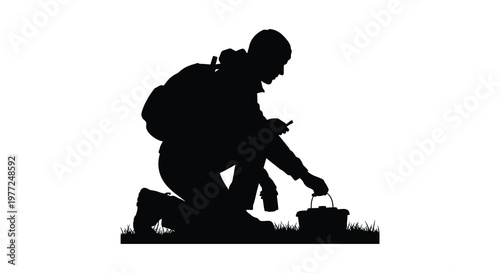 Soldier kneeling examining contents of a basket detailed black silhouette