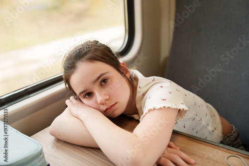 Thoughtful girl looking ahead during train trip