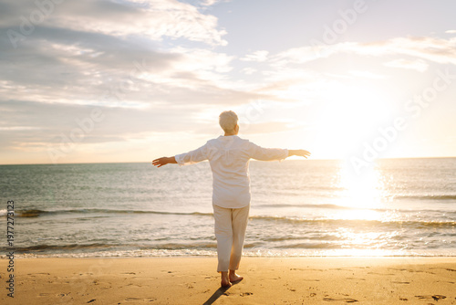 Tableau sur toile A gray-haired woman enjoys the seascape at sunset