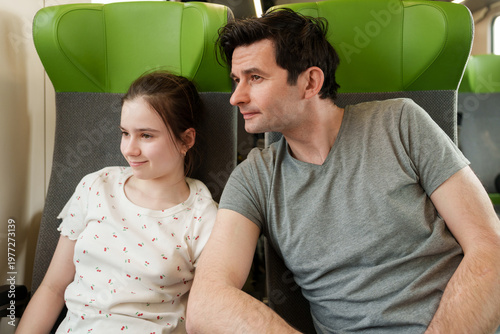 Father and daughter traveling together by train