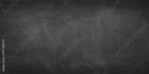 A blank vintage chalkboard with a dark grunge texture on an old grey concrete wall backdrop provides an empty black surface frame for design