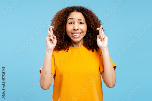 Tableau sur toile African American woman crossing fingers hoping for luck