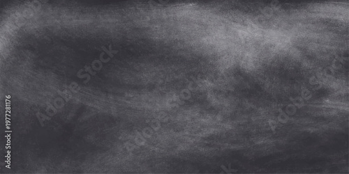 Empty vintage black chalk board with a dirty grunge texture on a dark rough surface creates a blank gray blackboard background for design