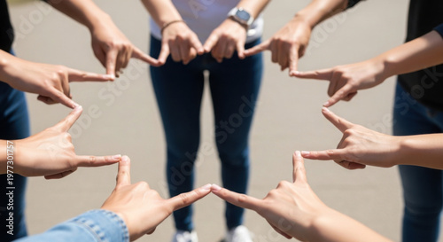 Group of hands forming a star shape in outdoor setting  