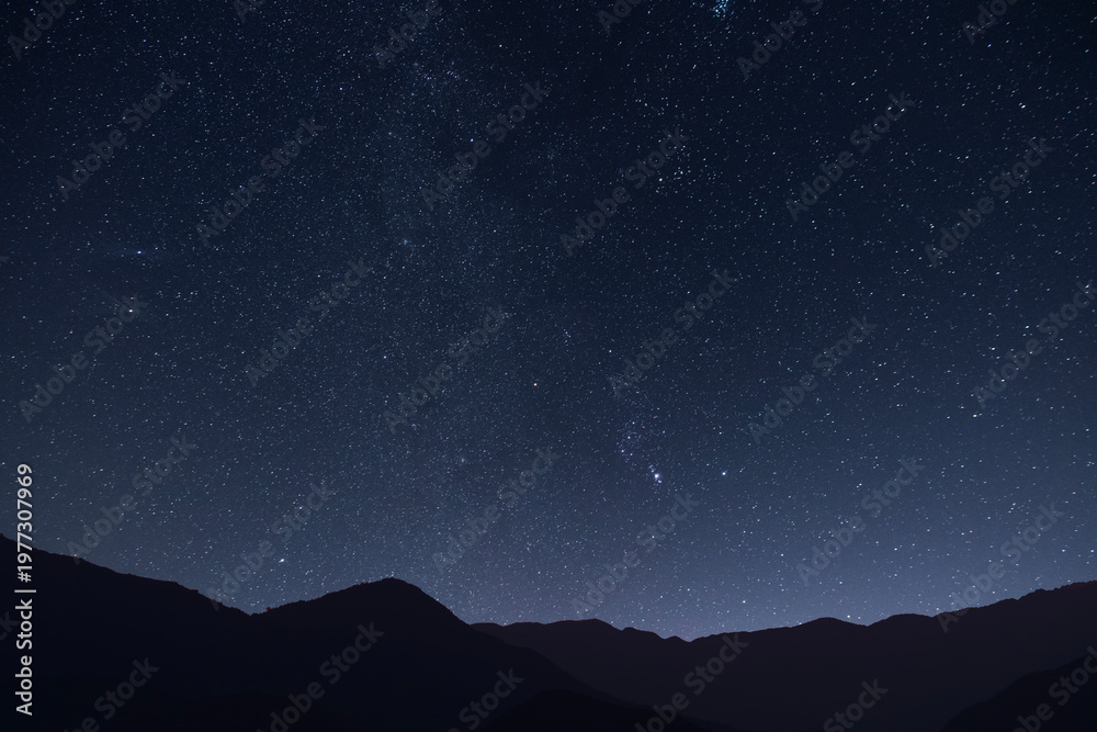 Fototapeta premium Night landscape, mountains under bright colorful milky way galaxy. Space, night scene time lapse.