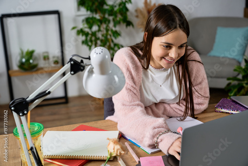 Tableau sur toile Teen girl enjoying a cozy afternoon while studying at home in a modern apartment