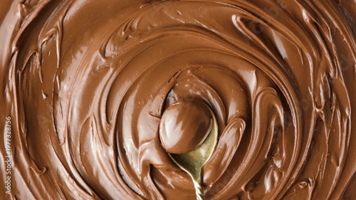 Macro shot of glossy delicious cocoa nut butter on spoon.