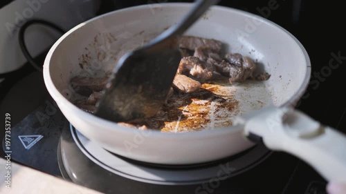 Close-up of Australian beef sticking to a pan during frying on a stovetop. Suitable for cooking problems, kitchen mistakes, and food preparation themes.