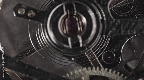 Close look at watch movement parts showing gears, springs, and mechanical features in action at a watchmaker's workshop