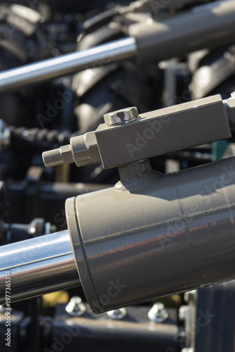 Gray piston or actuator in black pneumatic or hydraulic machine. Technology