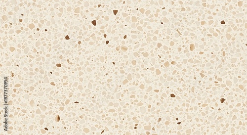 Close up of a speckled beige and cream terrazzo surface texture with small brown flecks, abstract background pattern