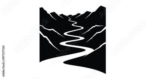 Winding mountain road cuts through peaks a striking silhouette