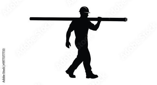 Worker carrying a pipe across his shoulders dramatic silhouette