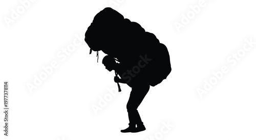 Man carrying a heavy load on his back dramatic silhouette
