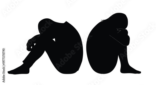 Two figures in distress seated and embracing knees silhouette