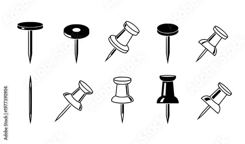 A set of black and white push pins in various orientations