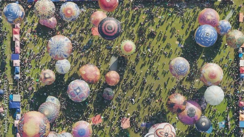 Overhead Crowd and Balloon Festival Scene with Long Shadows on Field