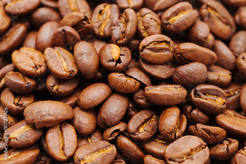Dark roasted coffee beans on a table ready for brewing coffee
