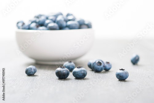 bilberry fruits at china bowl, on dark wood table