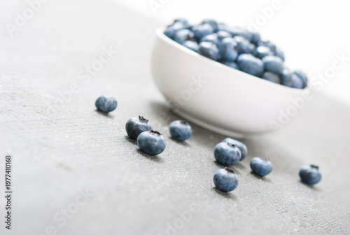 bilberry fruits at china bowl, on dark wood table