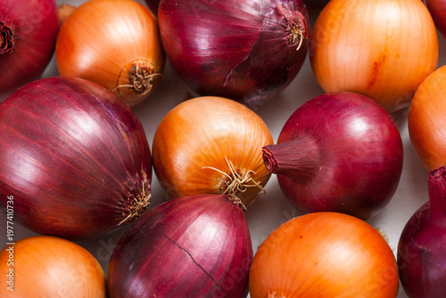 onions on white wood tray, wooden table background