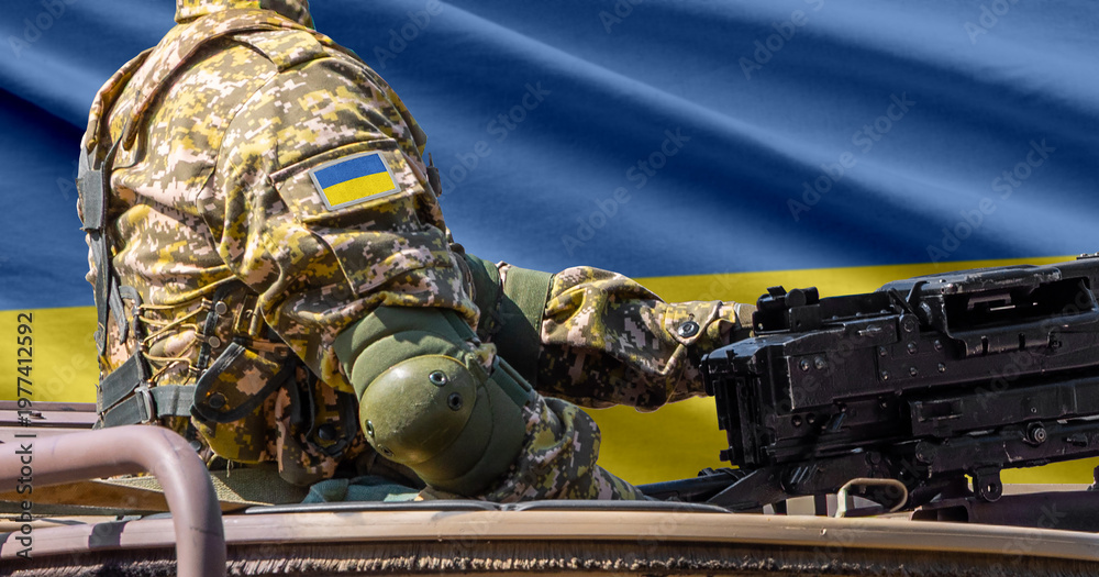 Obraz premium Ukraine flag with soldier at machinegun turret
