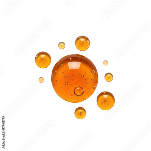 Amber colored liquid droplets and spheres isolated on black background, bubble