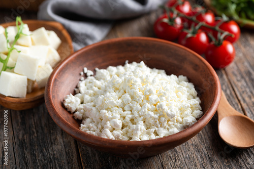 Curd cheese in red clay bowl (cottage cheese, tvorog)