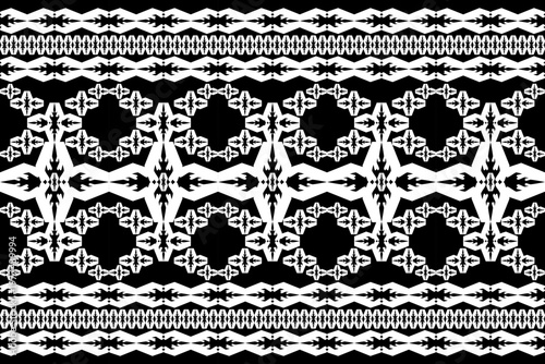 A seamless black and white geometric tribal pattern with repeating diamond and pixel-style motifs. Bold and symmetrical design ideal for textiles, wallpaper, and decorative graphic use.