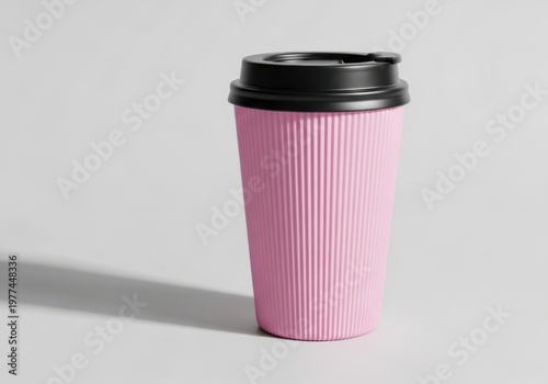 A pink ribbed coffee cup with a black lid