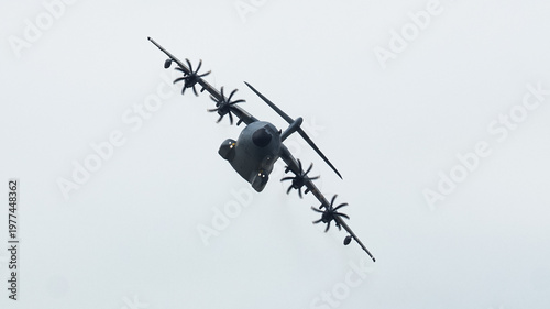 Dynamic Airbus A400M Atlas soaring through the clouds during a tactical airlift and aerial refueling mission