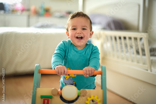 young child taking their first steps with a walker