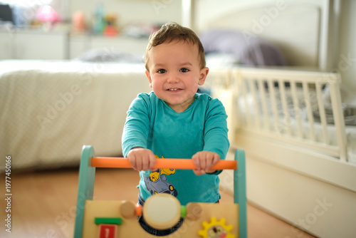 young child taking their first steps with a walker