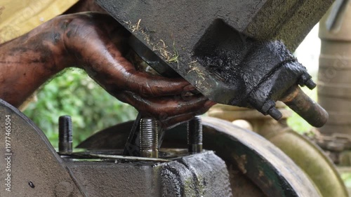 Hands Repairing Rusted Industrial Machine Part