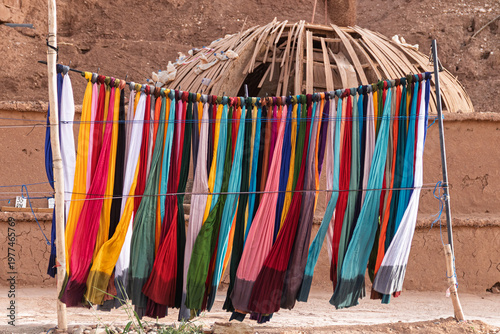 Colorful textiles hanging for sale in a moroccan village