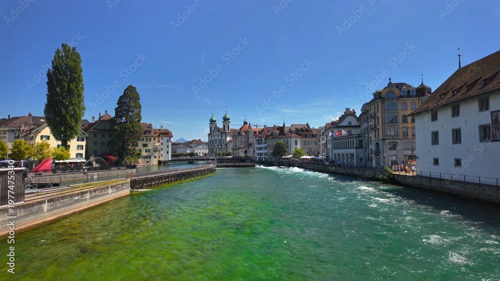 Obraz premium Lucerne riverfront with urban scenic view, highlighting popular Swiss travel destination and beautiful city landscape