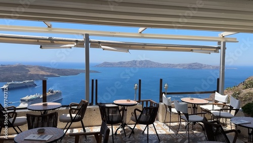 Restaurant view to Aegean Sea in Santorini, showcasing coastal cliffs, blue water, and relaxing Mediterranean dining experience