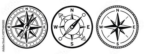 Set of three vintage compasses with cardinal directions and detailed star designs on checkered background