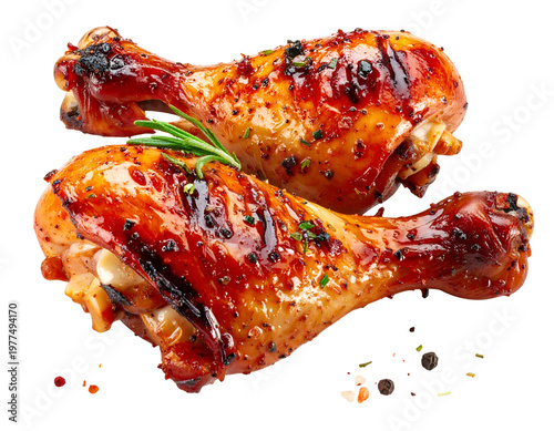 Two glistening, seasoned, roasted chicken drumsticks with herbs