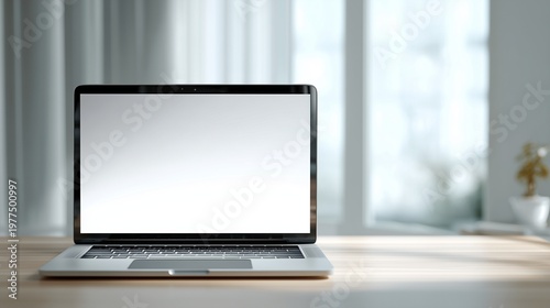 Blank white laptop screen mockup on a wooden desk near a bright window with natural sunlight