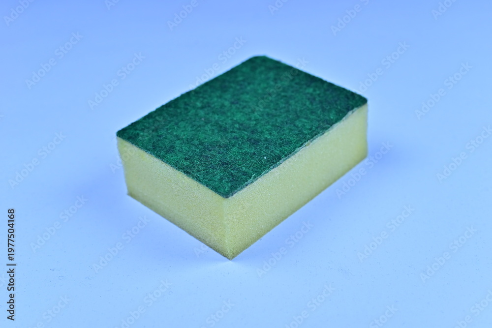 Fototapeta premium Single yellow sponge with a green abrasive scouring pad isolated on a white background.