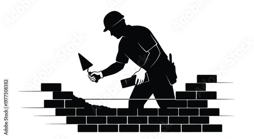 A mason works with bricks and mortar showcased in a striking silhouette