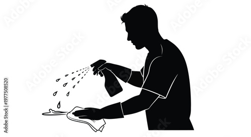 Man spraying and wiping a surface demonstrating cleaning with a stark silhouette