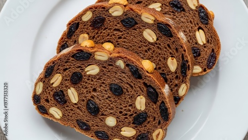 Wallpaper Mural Sliced chocolate bread with nuts and raisins on white plate Torontodigital.ca