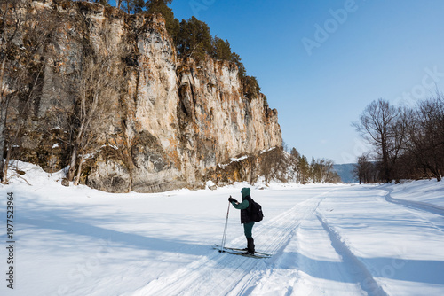 Individual Rests And Examines Icy Terrain Carefully. Skier Takes Break And Assesses Surrounding Icy Landscape. An Individual Halts In Cold Snow And Studies Cliff Face Ahead Closely