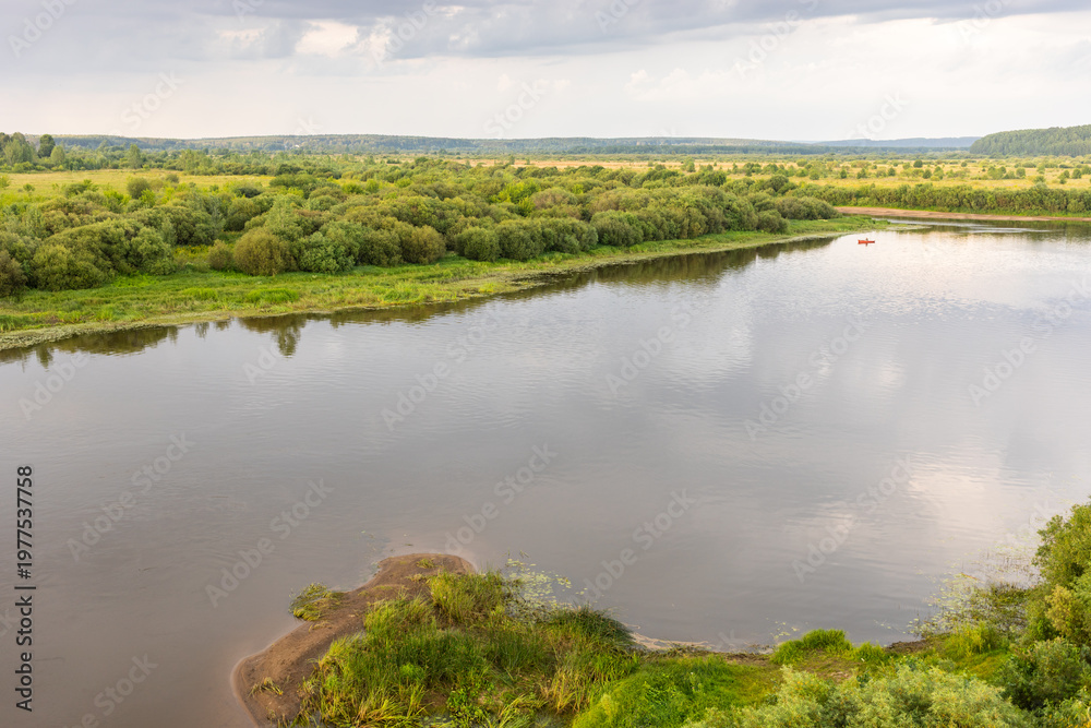 Ταπετσαρία Wide river with banks with lush vegetation, waterlogged blanks and calm water re