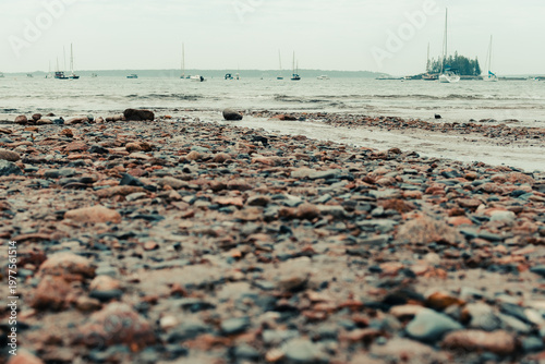 Rocky beach with boats in the bay