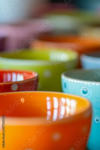 Group of colorful bowls on a table, great for food or decoration illustration. vertical frame
