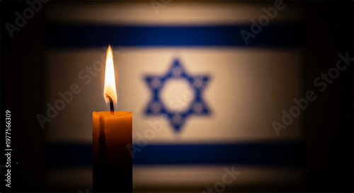 Single lit candle burning in the darkness with a blurred Israeli flag behind it symbolizing grief and solemn national remembrance in a studio shot