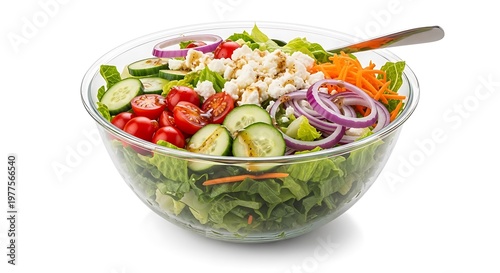 Fresh garden salad in clear glass bowl with feta cheese cherry tomatoes cucumber onion carrot.